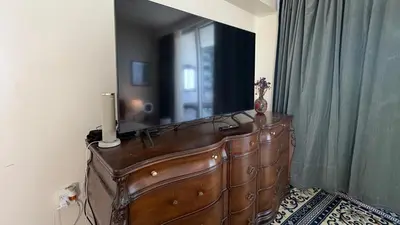 a brown dresser in a room with a mirror at Urban Warmth Retreat in Miami