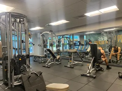 a gym with lots of machines and people in it at Urban Warmth Retreat in Miami