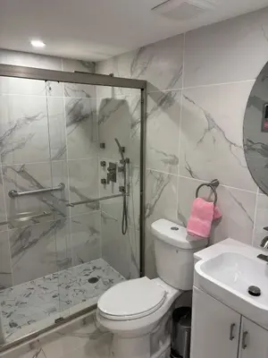 a bathroom with a shower and a toilet and a sink at Peace and Tranquility awaits in Miami Gardens