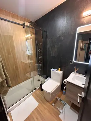 a bathroom with a toilet and a shower and a sink at Cozy Home away from home! in Miami