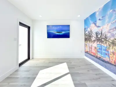 an empty room with a large painting on the wall at Lux Miami Escape - Near Brickell- Free Parking in Miami