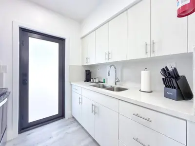 a white kitchen with a sink and a window at Lux Miami Escape - Near Brickell- Free Parking in Miami