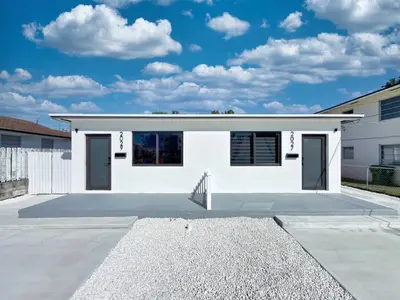 a white house with a parking lot at Lux Miami Escape - Near Brickell- Free Parking in Miami