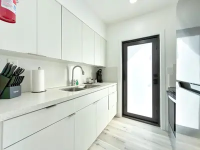 a white kitchen with a sink and a window at Miami Lux Retreat - Free Parking - Near Brickell in Miami