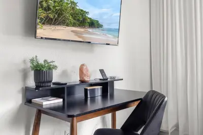 a desk in a room with a picture of a beach at Unit 1 Cozy 1BR Apt with Parking in Miami