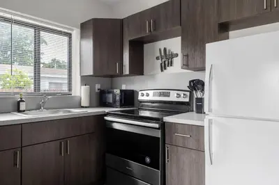 a kitchen with a stove and a white refrigerator at Unit 1 Cozy 1BR Apt with Parking in Miami
