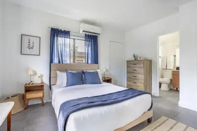 a bedroom with a large bed with blue pillows at Unit 4 Beautiful 1BR Apt w Parking Near Biscayne Blvd in Miami