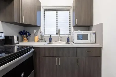 a kitchen with a sink and a microwave at Unit 4 Beautiful 1BR Apt w Parking Near Biscayne Blvd in Miami
