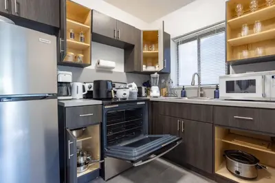 a kitchen with a stainless steel refrigerator and cabinets at Unit 4 Beautiful 1BR Apt w Parking Near Biscayne Blvd in Miami