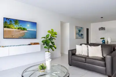 a living room with a couch and a glass table at Hollywood 1 BR Apt w Gym and Pool near the Beach in Hollywood