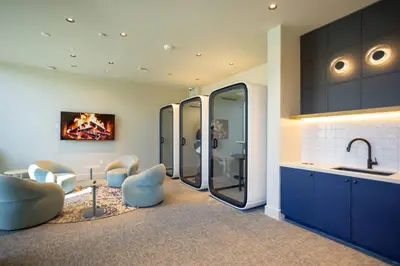 a kitchen with blue cabinets and chairs and a sink at 72 Park Ocean view 1BR Apartment with Pool and Gym in Miami Beach
