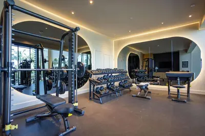 a gym with a lot of tread machines and a mirror at 72 Park Ocean view 1BR Apartment with Pool and Gym in Miami Beach