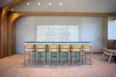 a bar with chairs and a painting on the wall at 72 Park Ocean view 1BR Apartment with Pool and Gym in Miami Beach