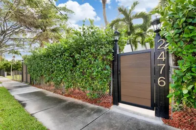 a gate to a driveway with a fence at Casa Palma in Miami