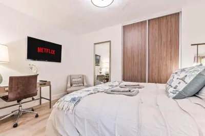 a bedroom with a bed and a desk and a chair at Casa Palma in Miami