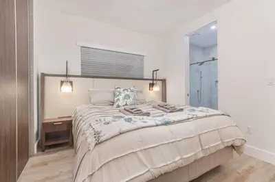 a bedroom with a large bed and a desk at Casa Palma in Miami