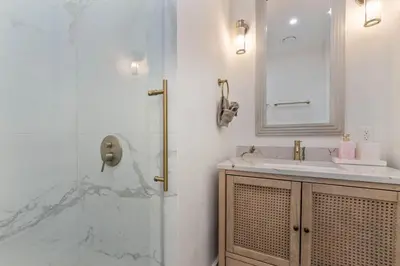a bathroom with a shower and a sink and a mirror at Casa Palma in Miami