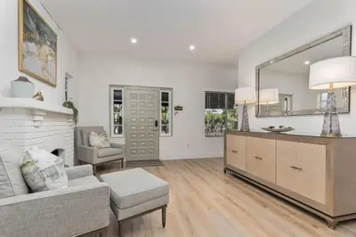 a living room with a couch and a mirror at Casa Palma in Miami