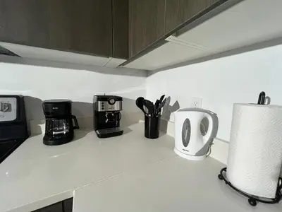 a kitchen counter with appliances on a counter top at Live Miami Vibes 2 Bedrooms Bayside Steps City Views Pool in Miami