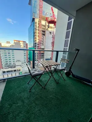 two chairs and a table on a balcony with a view at Live Miami Vibes 2 Bedrooms Bayside Steps City Views Pool in Miami