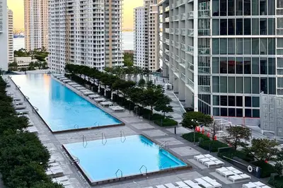 an overhead view of two large swimming pools in a city at Modern 1B at Icon Brickell 32nd fl Pool Spa Gym FREE Parking Scenic view in Miami