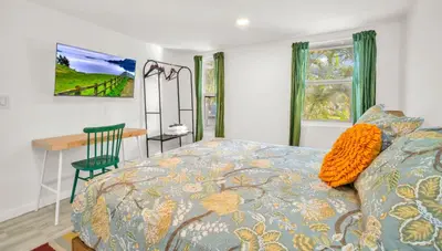 a bedroom with a bed and a desk with a chair at Later Gator - Pool - Canal - Wilton Drive in Fort Lauderdale