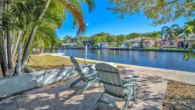 two chairs sitting next to a body of water at Later Gator - Pool - Canal - Wilton Drive in Fort Lauderdale