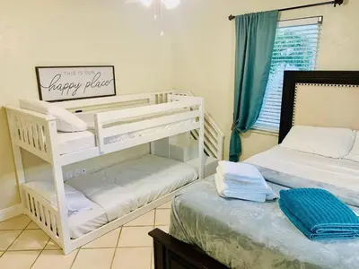 a bedroom with two bunk beds and a window at Cozy three bedroom near Hollywood beach in Hollywood