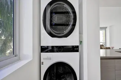 a washer and dryer in a kitchen next to a window at Ocean View 3 BDR Condo Pool Gym Private Balcony in Hallandale Beach