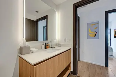 a bathroom with a sink and a mirror at Miami 30th floor 3BR Luxury Condo with Views in Miami