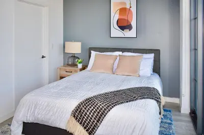 a bedroom with a large bed with pink pillows at The Juliet VIII Vibe 8706 in Miami