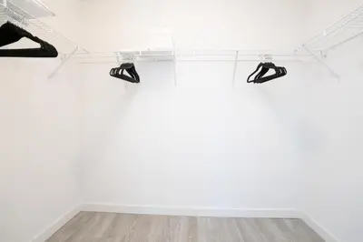 two pairs of shoes on a shelf in a white room at The Juliet XIV Vibe 8801 in Miami