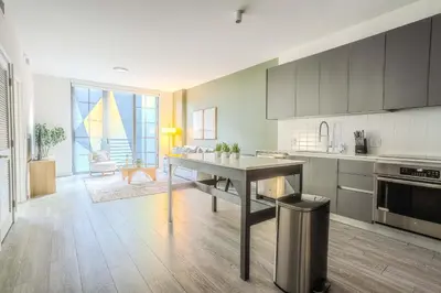 a kitchen with a table in the middle of a room at The Juliet XIV Vibe 8801 in Miami