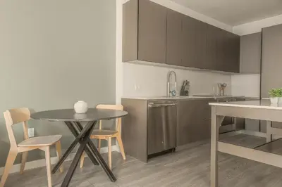 a kitchen with a table and a table and chairs at The Juliet XIV Vibe 8801 in Miami
