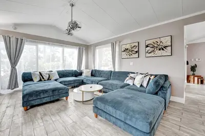 a living room with blue couches and a table at Oasis 5 Bed, 3 Bath Pool Home Minutes to the Beach in Hollywood