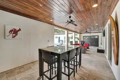 a kitchen with a table with chairs and a ceiling at Oasis 5 Bed, 3 Bath Pool Home Minutes to the Beach in Hollywood