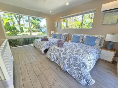 a bedroom with a bed and a large window at Oasis 5 Bed, 3 Bath Pool Home Minutes to the Beach in Hollywood