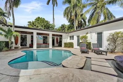 a swimming pool with a patio and a house at Oasis 5 Bed, 3 Bath Pool Home Minutes to the Beach in Hollywood