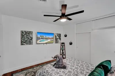 a bedroom with a ceiling fan and a bed at Stylish 4 Bed 2 Bath Pool & Spa in Hollywood