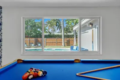 a pool table in a room with a window at Stylish 4 Bed 2 Bath Pool & Spa in Hollywood