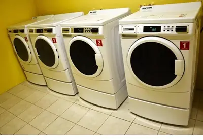 three washing machines and a washer and dryer in a room at Beautiful Sunny Isles apt 1br with PRIVATE TERRACE in Sunny Isles Beach