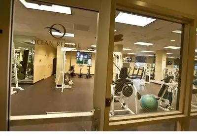 a gym with treadmills and machines and a glass door at Beautiful Sunny Isles apt 1br with PRIVATE TERRACE in Sunny Isles Beach