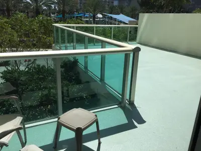 a balcony with a chair and a swimming pool at Beautiful Sunny Isles apt 1br with PRIVATE TERRACE in Sunny Isles Beach