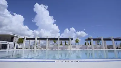 a building with a swimming pool in front of it at 3B-2B in Resort style community- Prime Miami Spot in North Miami
