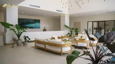 a living room with couches and chairs and plants at 3B-2B in Resort style community- Prime Miami Spot in North Miami