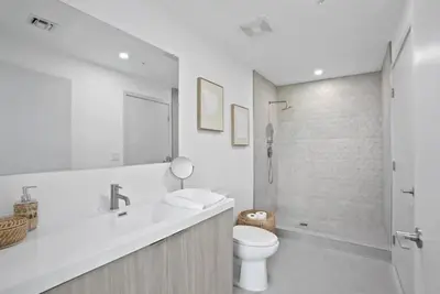 a bathroom with a toilet and a sink and a shower at High Floor Property-Expansive Views- Sleep 6 Miami in North Miami