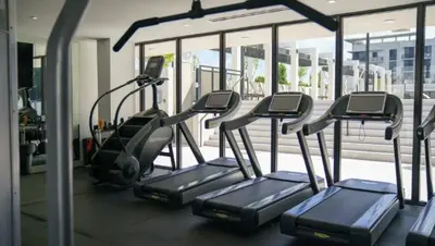 a row of treadmills in a gym at Sleep 6 in Resort Style Community- Near Stadium in North Miami