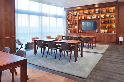 a dining room with tables and chairs and a television at The Grayson Hotel Miami Downtown in Miami
