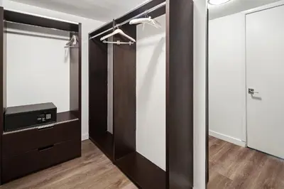 a walk in closet with a mirror and a television at The Grayson Hotel Miami Downtown in Miami