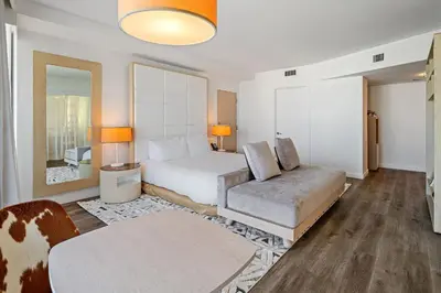 a hotel room with a bed and a couch at The Grayson Hotel Miami Downtown in Miami
